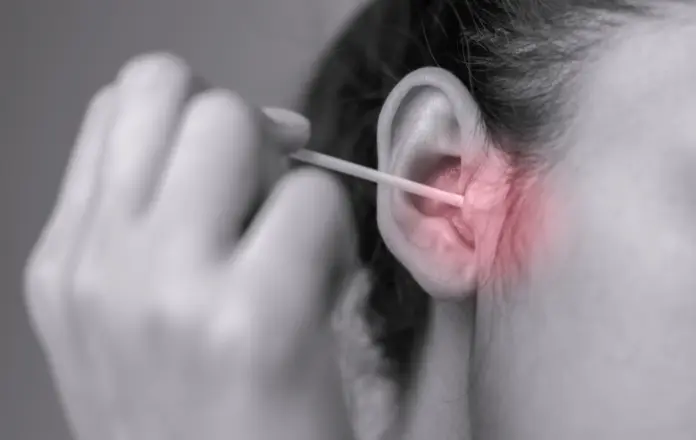 Woman sticking a cotton bud in her ear