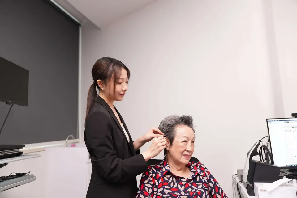 Elderly woman getting fitted for hearing aids