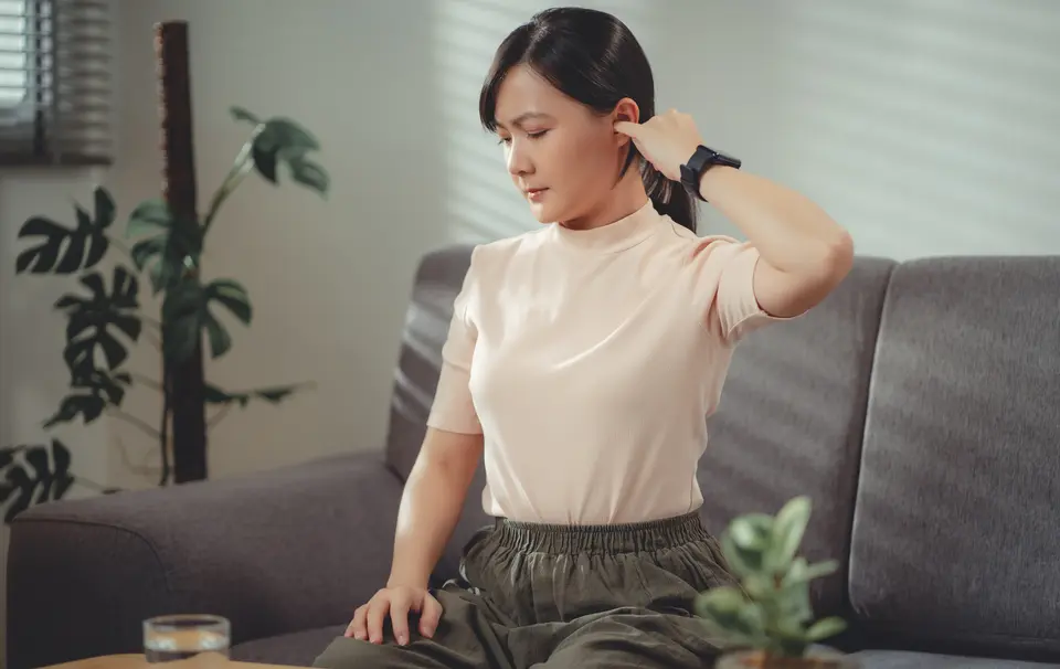 Lady scratching her itchy ears